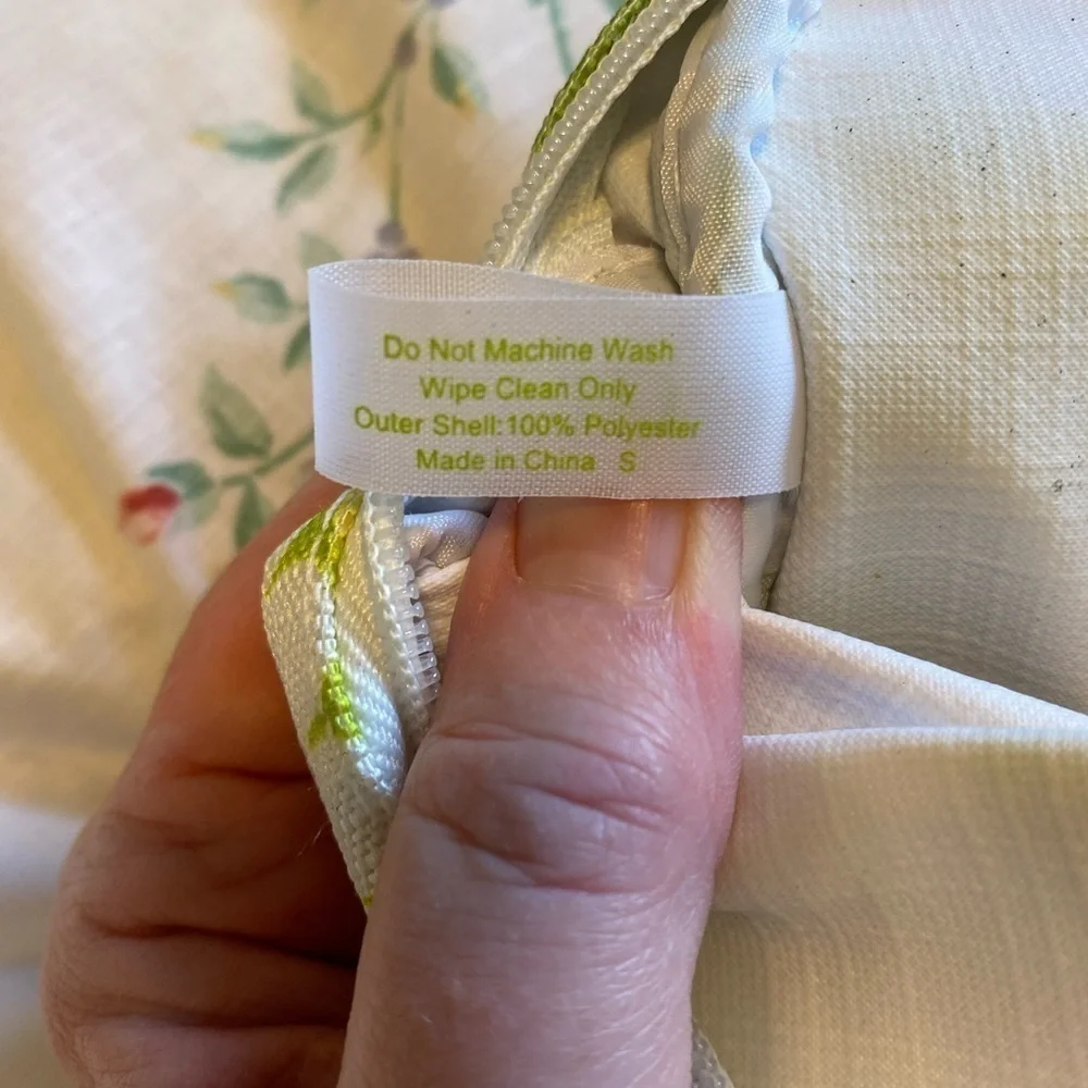 Clinique NWOT cosmetic bag. Green, yellow, purple and white. White inside